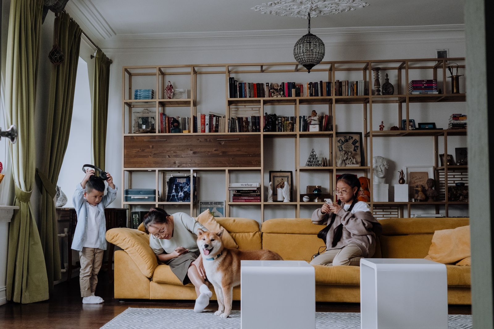 Family relaxing together with their dog in a living room